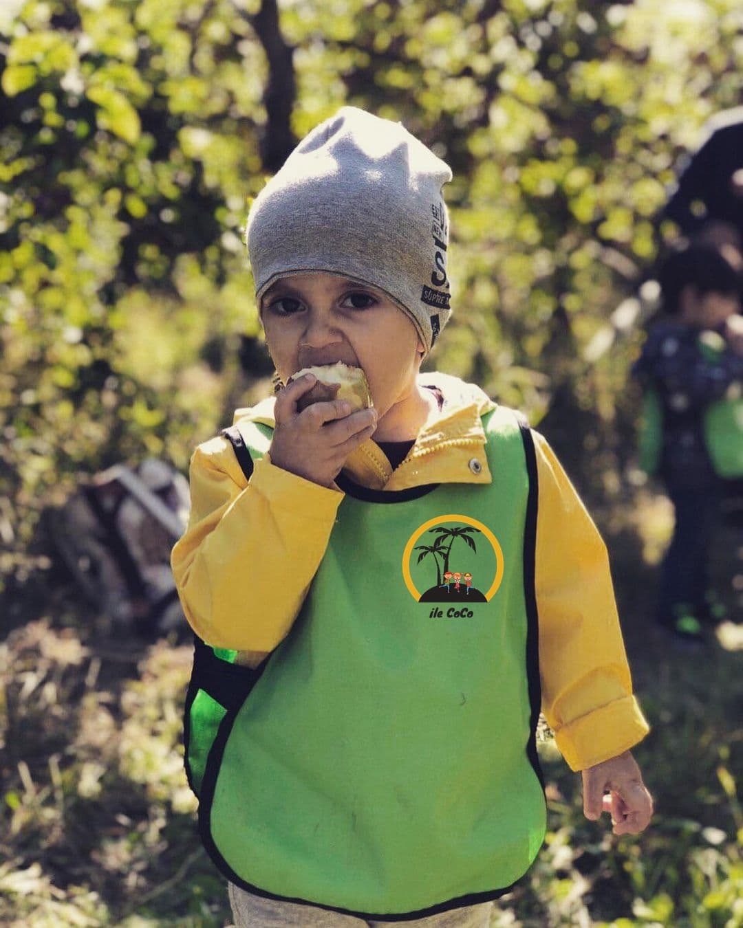 Child at Ile Coco bilingual daycare in NDG, Montréal — autumn apple-picking outing